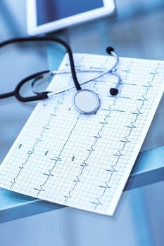 stethoscope and electrocardiogram on the table from the therapist.the photo is a blank space for your text