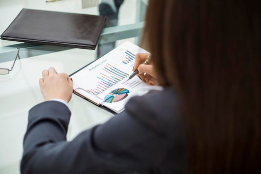 closeup of business team discussing financial charts on a workplace in a modern office