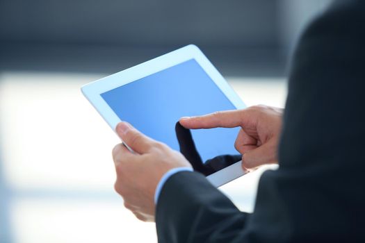 businessman holding digital tablet in office