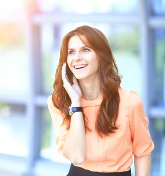 Modern successful business woman in the office talking on the phone