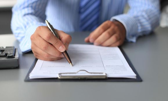 Businessman hands pointing at business document. Closeup.