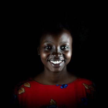 Dark portrait of young black woman in studio