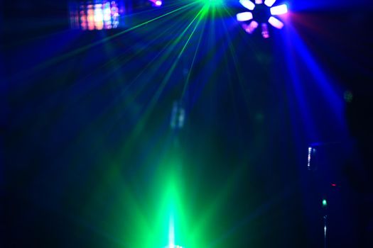 Lighting disco with bright beams of searchlight, laser show.