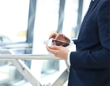 Midsection of businessman using digital tablet in office