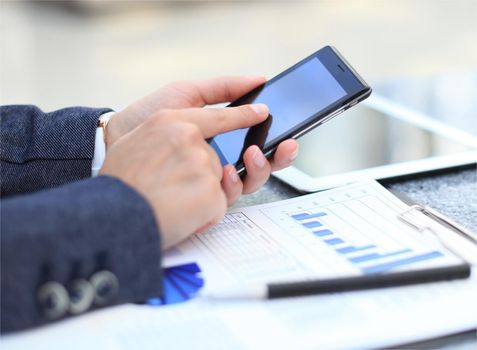 Close up of a business woman using mobile smart phone