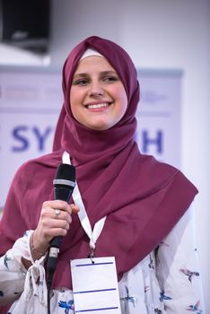 young muslim businesswoman at business conference room with public giving presentations. Audience at the conference hall. Entrepreneurship club