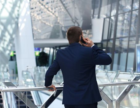 back view of a business man talking on his smartphone