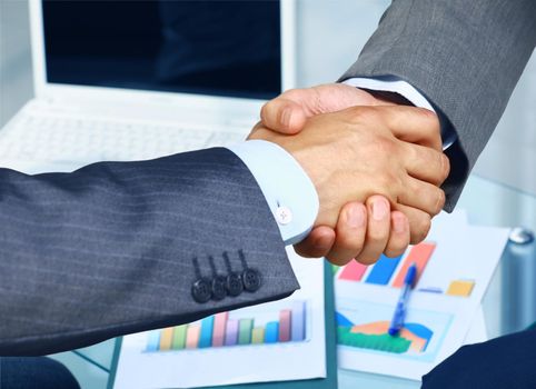 Closeup of a business hand shake between two colleagues