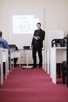 young business man giving presentation and education leassons on seminar event in small bright conference room