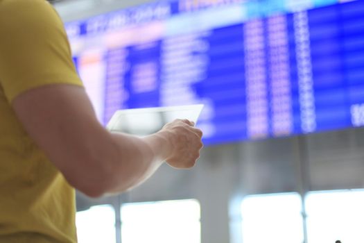 Man makes check-in with touchpad at airport