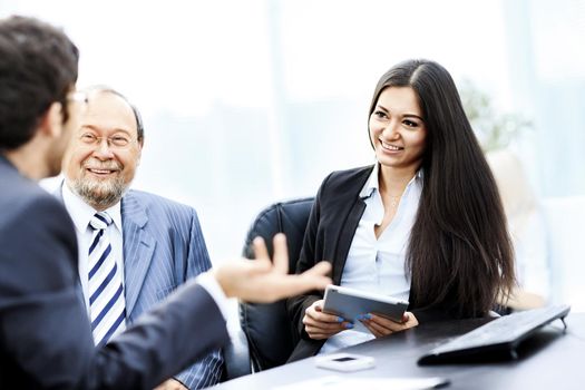 Image of business partners discussing documents and ideas at meeting in office