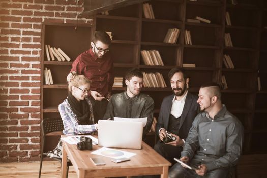 positive creative team of copywriters in the workplace in a modern office