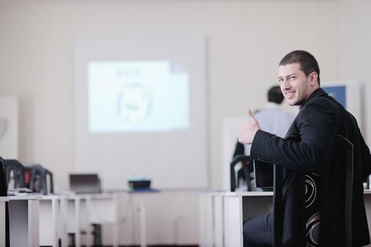 young business man giving presentation and education leassons on seminar event in small bright conference room