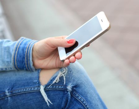 Close up of a woman using mobile smart phone