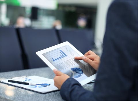 Businessman using digital tablet computer with modern mobile phone