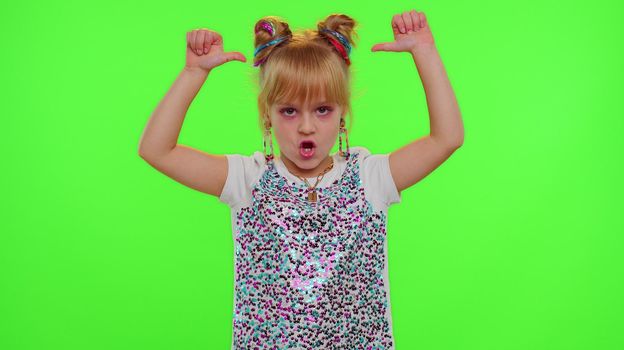 Stylish kid girl making trendy dance video for social media network, child dancing, blogger fun activity challenge, children hobbies games after school. Schoolgirl child on green chroma key background