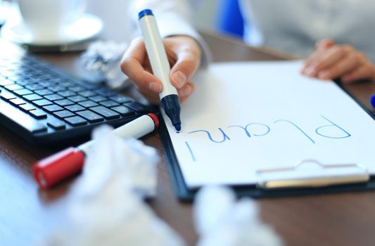 Business woman writing blank plan list