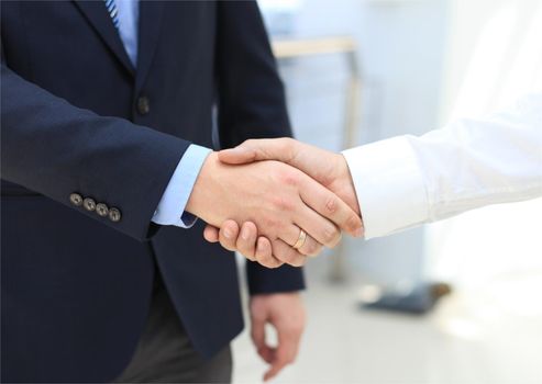 Closeup of a business hand shake between two colleagues