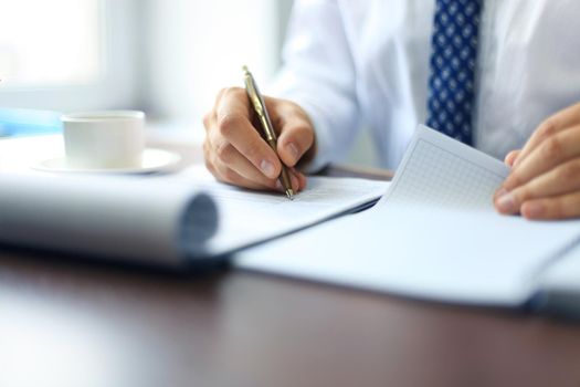 Close-up of Businesswoman makes a note at business document