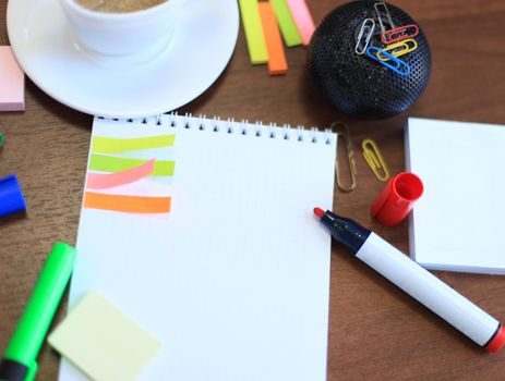 Workspace with coffee cup, note paper on table