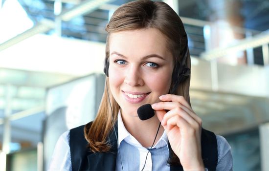 Customer support operator working in a call center office