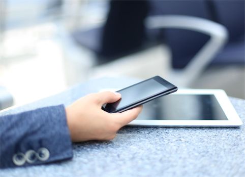 Close up of a business woman using mobile smart phone