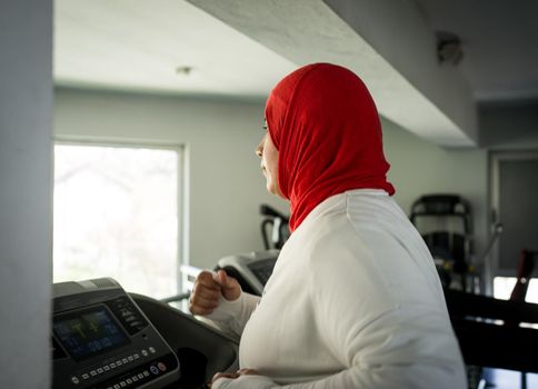 Arabic woman active working out in big gym