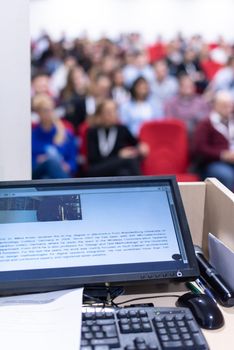 laptop computer at podium on business seminar education  in modern conference room