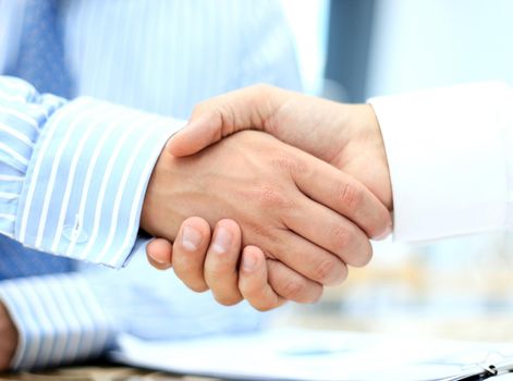 Closeup of a business hand shake between two colleagues