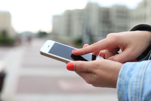 Close up of a woman using mobile smart phone