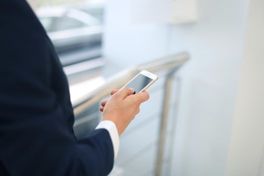 Close up of a business man using mobile smart phone