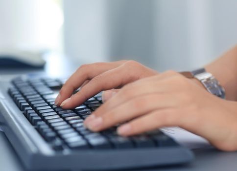 Human hands working on computer on office background