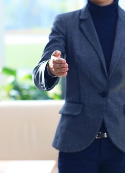 Midsection of a businesswoman with an open hand ready to seal a deal