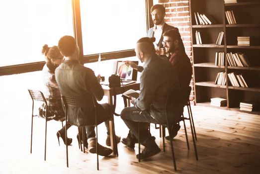 group of designers discussing a new color palette in the workplace in a modern office. the photo has a empty space for your text