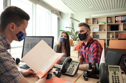 Successful lawyer in protective mask giving consultation to family couple about buying house