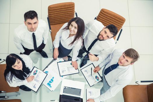 top view is a professional business team developing a new financial strategy of the company at a work location in a modern office.