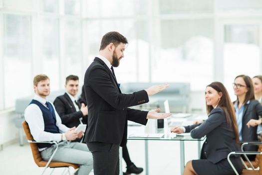 senior Manager of the company holds a working meeting with business team in modern office. the photo has a empty space for your text.
