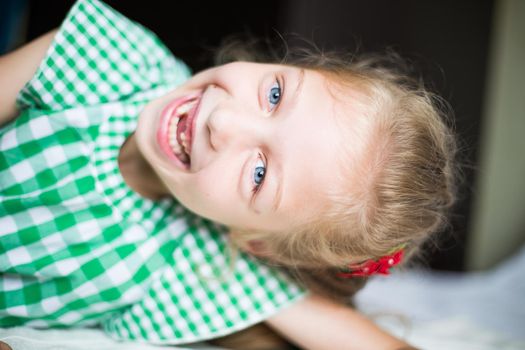 portrait of smiling cute little girl in the nursery.