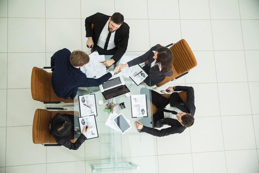 top view of business partners shaking hands after a discussion of the new fiscal Treaty.the photo is a blank space for your text