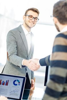 closeup - the lawyer and the client, shake hands after signing the financing contract.