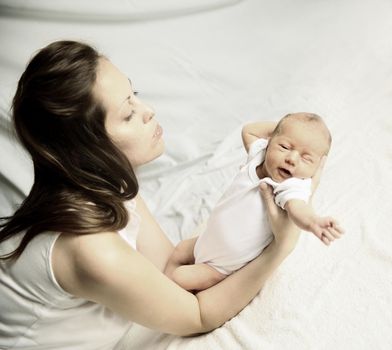 portrait of a young mother with a newborn baby.the photo has a space for your text