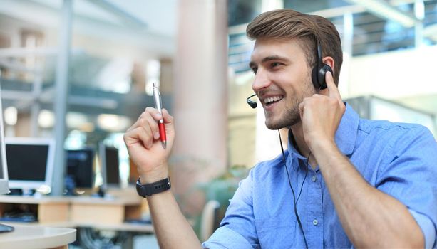 Smiling friendly handsome young male call centre operator