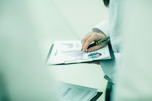 accountant works with financial graphs.photo on a light background and has an empty space for your text