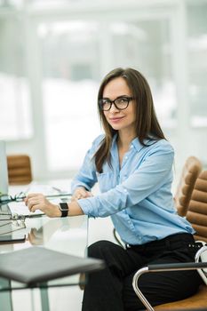 business woman at workplace in the modern office .the photo has a empty space for your text