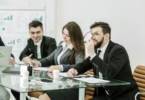 business team of professionals prepares a presentation of a new financial project.the photo has a empty space for your text