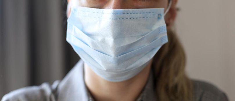Close-up portrait of young woman wears a protective medical mask against viruses and infections and coronavirus covid-2019
