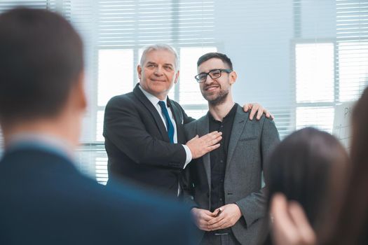 project Manager congratulating the best employee at a meeting with the working group. photo with copy-space