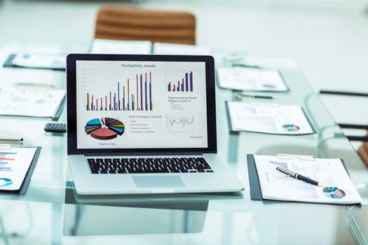 close-up of a financial graph on the screen of the laptop in the workplace of the financier. the photo is a blank space for your text
