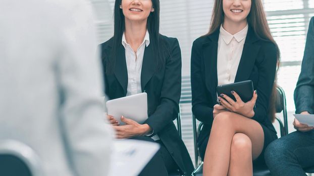 close up. employees asking questions at a work meeting . business concept