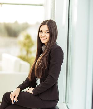 young prospective female employee on the background of a large window in the office